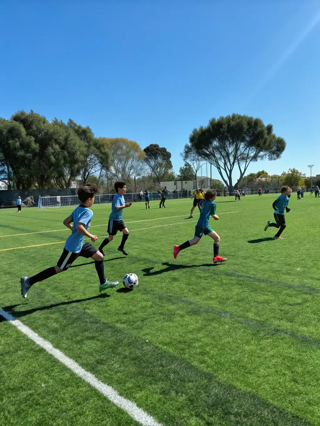 Students participating in a football match on the school's sports field, showcasing their agility and competitive spirit.